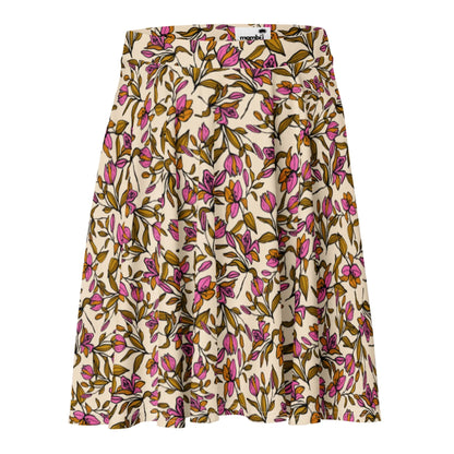 A knee-length Mambí skirt with a beige background featuring an all-over floral print in pink, yellow, and green. The skirt has soft pleats and a fitted waistband.