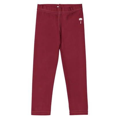 Burgundy leggings with white stitching and a small white palm tree graphic on the upper left hip. Featuring a Mambí-inspired, simple fitted design and an elastic waistband.
