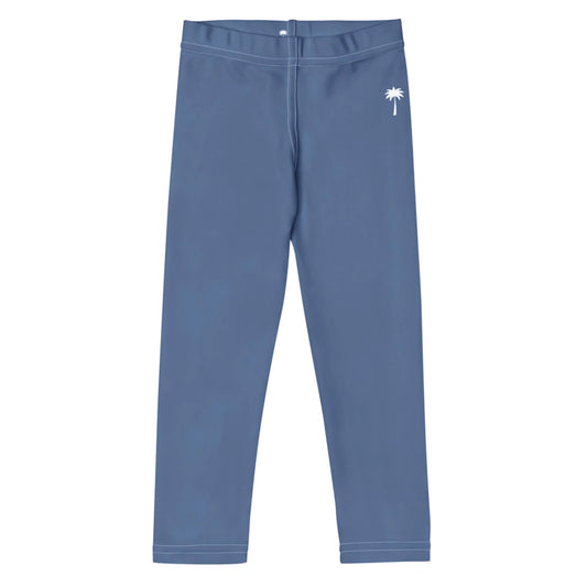 Blue Mambí leggings with a white palm tree graphic on the left hip, laid flat on a white background.