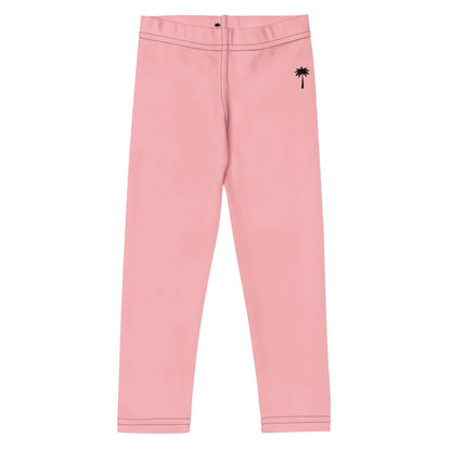 Light pink Mambí pants with a black palm tree graphic near the left hip; these fitted pants feature a button at the waistband and visible black stitching at the waist and cuffs.