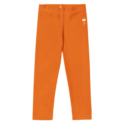 Bright orange Mambí leggings with white stitching and a small white palm tree graphic near the left hip, displayed flat on a white background.
