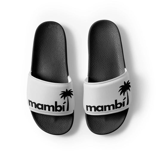 A pair of Printful Malibu Chancleta Slides for men in Black/Whisper, featuring mambi and a palm tree graphic on the cushioned upper strap, viewed from above on a white background.