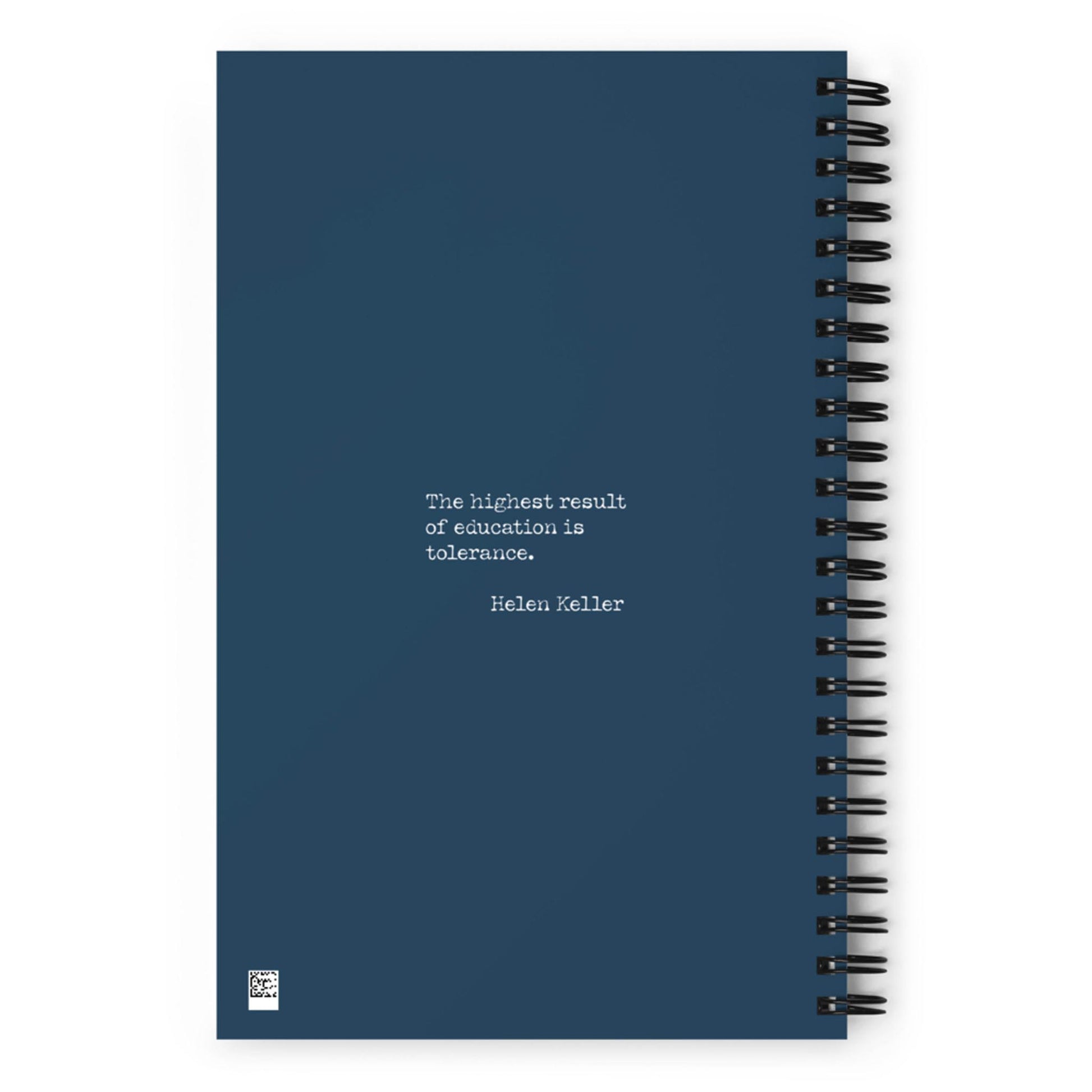A dark blue spiral notebook with the quote The highest result of education is tolerance. — Helen Keller printed in white text on the cover.