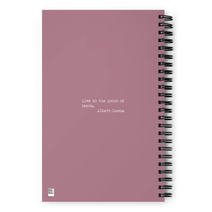 A mauve custom wire-bound notebook with the quote Live to the point of tears. Albert Camus printed in small white letters at the center. A small white square logo appears in the bottom left corner—perfect as your daily companion notebook.