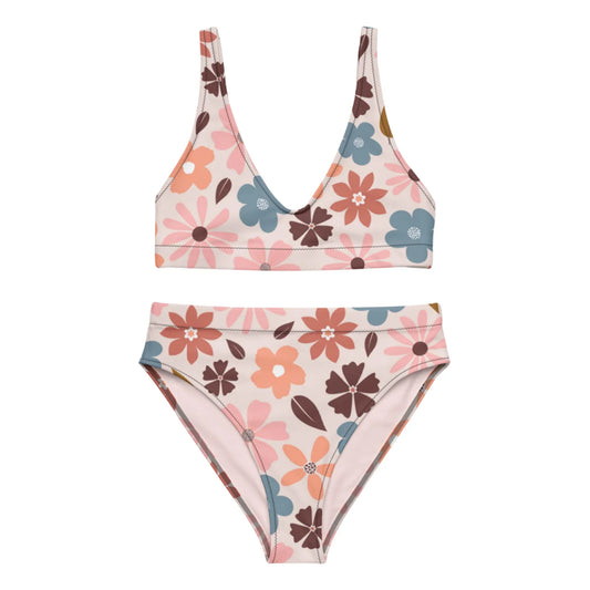 Two-piece Mambí bikini set with a V-neck top and high-waisted bottoms, both featuring a retro floral pattern in shades of pink, brown, orange, and blue on a light background.