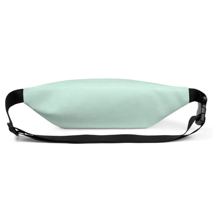 A light mint green Mambí fanny pack with a black adjustable strap and buckle, shown from the front on a white background.