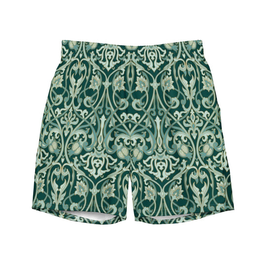 The Oz Swim Trunks by Printful feature an ornate, symmetrical vintage floral pattern in green and cream, with stylized vines and flowers. Made from water-repellent fabric for comfort in and out of the water.