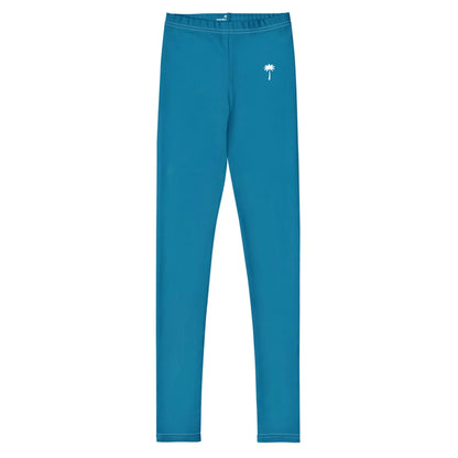 Bright blue Mambí leggings with a straight cut and a small white palm tree graphic on the left hip area, displayed on a plain white background.