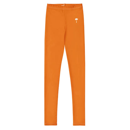 Bright orange Mambí leggings with a slim fit and a small white palm tree graphic on the left hip. The background is white.