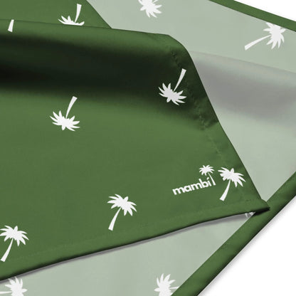 A green and light gray fabric with white palm tree silhouettes and the word Mambí printed on it, showing both sides of the material.