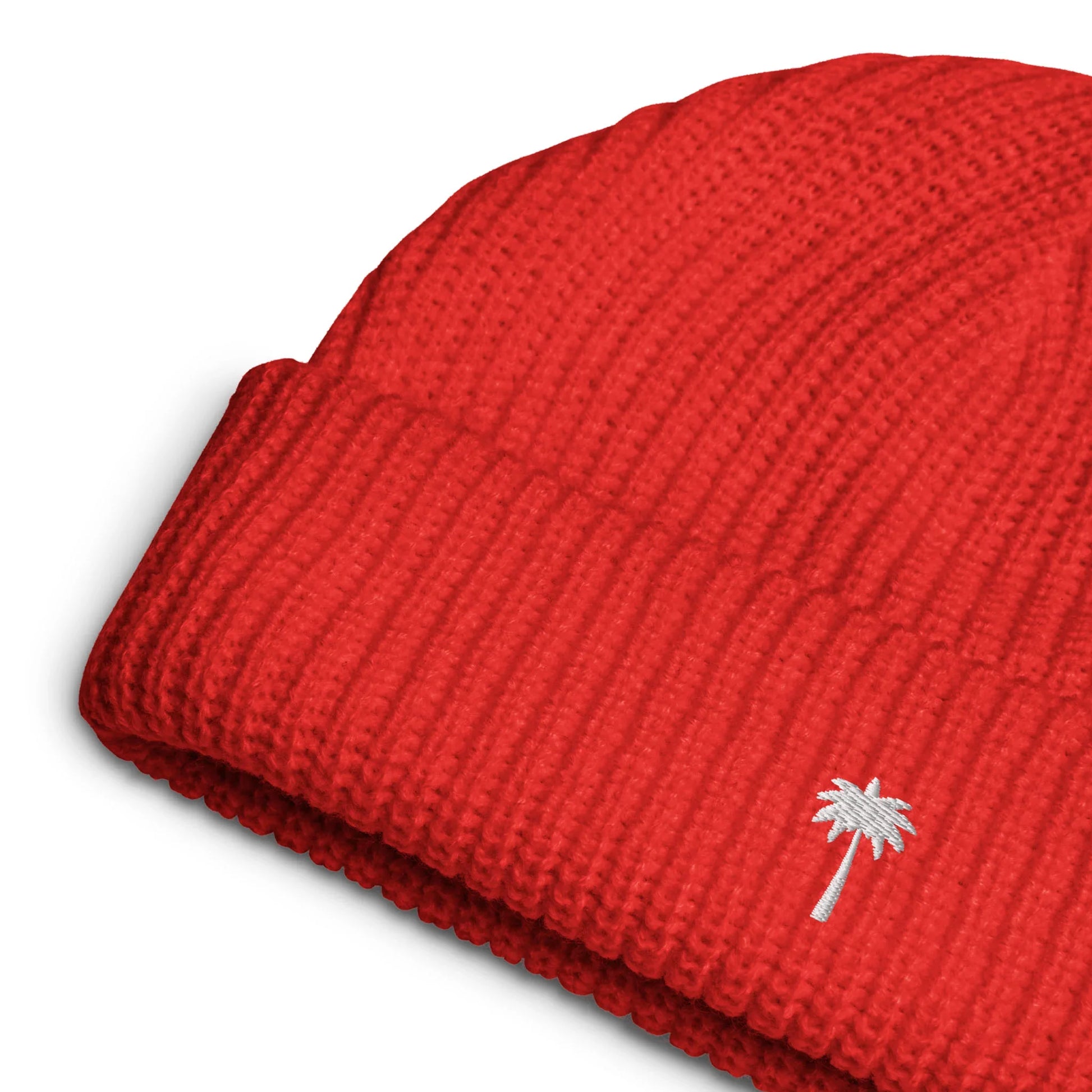 Red fisherman beanie with white palm tree embroidery on ribbed knit, close-up mockup