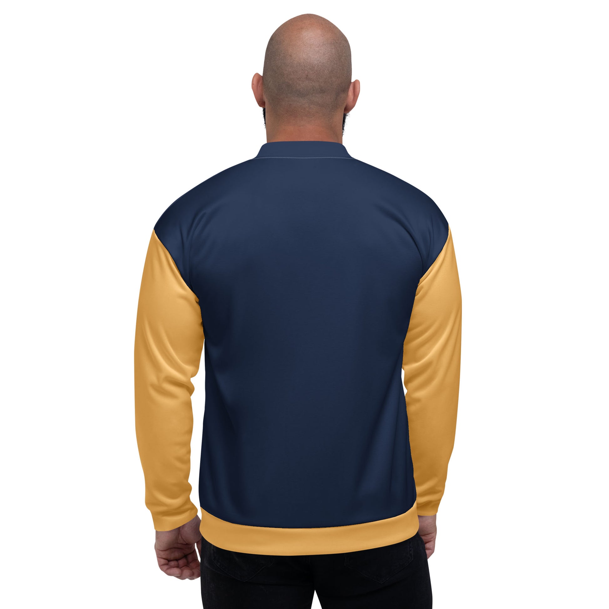 A bald man is shown from behind wearing a varsity bomber jacket with premium stitching, featuring navy blue on the back and yellow sleeves. He stands against a plain white background.