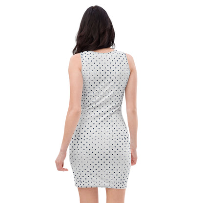 A woman with long dark hair is shown from the back, wearing a sleeveless fitted dress with a black polka dot pattern. The all-over printed dress stands out against the plain white background.