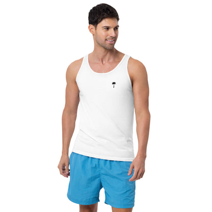 A man wearing a classic style tank top with a small palm tree graphic on the chest and blue shorts stands facing slightly right, smiling.