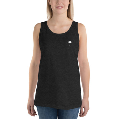 A smiling person wearing a sleeveless black tank top made from premium materials, featuring a small white palm tree graphic on the left chest, paired with blue jeans, standing against a plain white background.