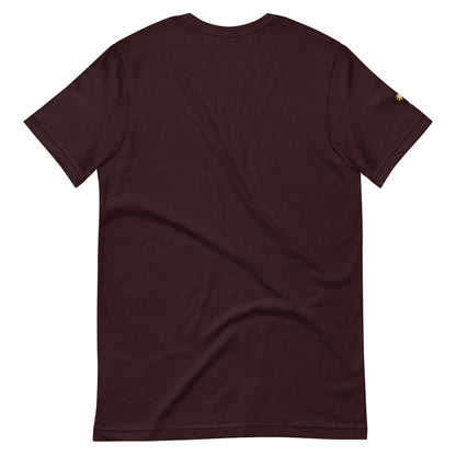 A plain, short-sleeve, dark maroon fitted shirt is shown laid flat with the back facing up. Made from comfortable cotton, it features a small, subtle gold detail on the edge of the left sleeve.