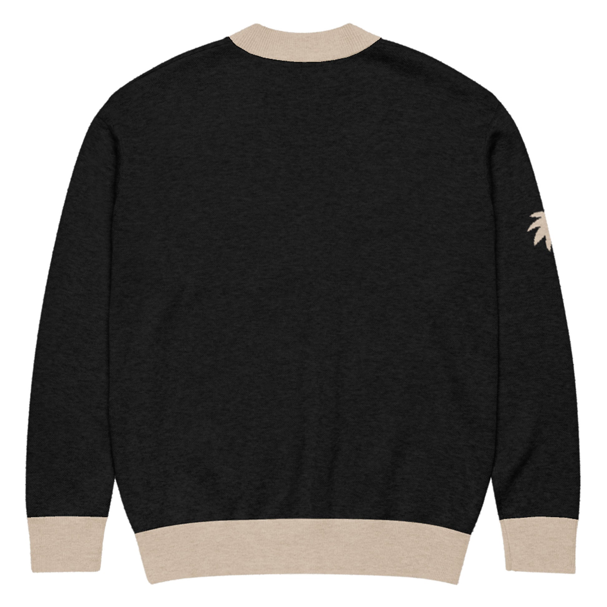 A black two-tone cardigan with beige cuffs, collar, and waistband. There is a small beige palm tree design on the right sleeve near the shoulder. The jacquard knit cardigan is shown from the back.