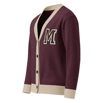 A lightweight knit maroon cardigan with cream-colored trim on the collar, button placket, and cuffs, featuring a large letter M patch on the left chest. This unisex sweater has black buttons and a varsity-style design.