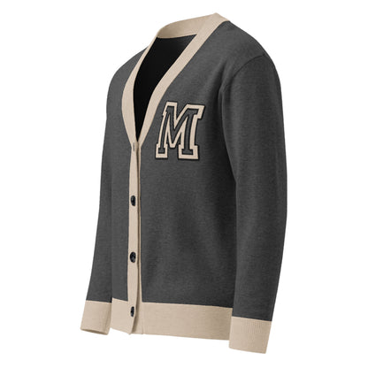 A unisex two-tone cardigan in dark gray with beige trim on the cuffs, hem, and neckline. Finished with black buttons down the front and a large, bold letter M patch on the left chest.