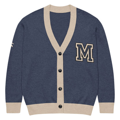 A soft, lightweight cardigan in navy blue with beige trim on the cuffs, hem, and neck. It features black buttons down the front and a large beige letter M patch on the left chest for a classic touch.