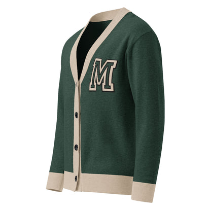 A two-tone cardigan in green with beige trim and cuffs, featuring a large white-outlined letter M patch on the left chest. This unisex cardigan has a V-neck and buttons down the front for classic style.