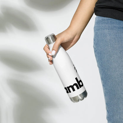 A person in blue jeans and a black shirt holds the Printful Pura Stainless Water Bottle, 17oz, in white with a silver cap and black text, against a plain light background.