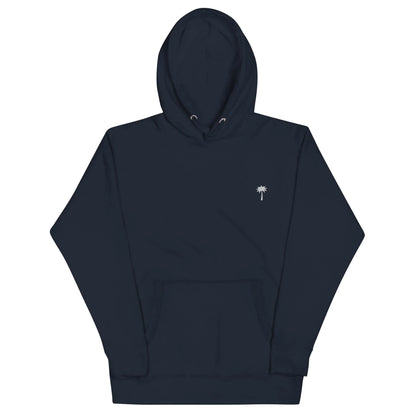 A plain dark navy blue Mambí hoodie with a front pouch pocket and a small white palm tree graphic on the left chest. The hood has drawstrings, and the sleeves and hem feature ribbed cuffs.