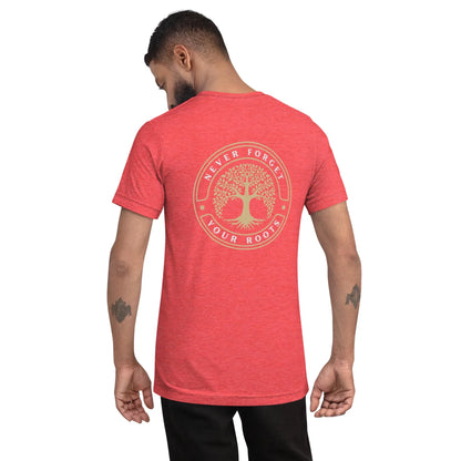 A man with short hair and tattooed forearms faces away, wearing the Printful Roots Tri-Blend Graphic Tee. The red unisex shirt features a soft tri-blend fabric, a circular tree graphic, and “Never Forget Your Roots” on the back.