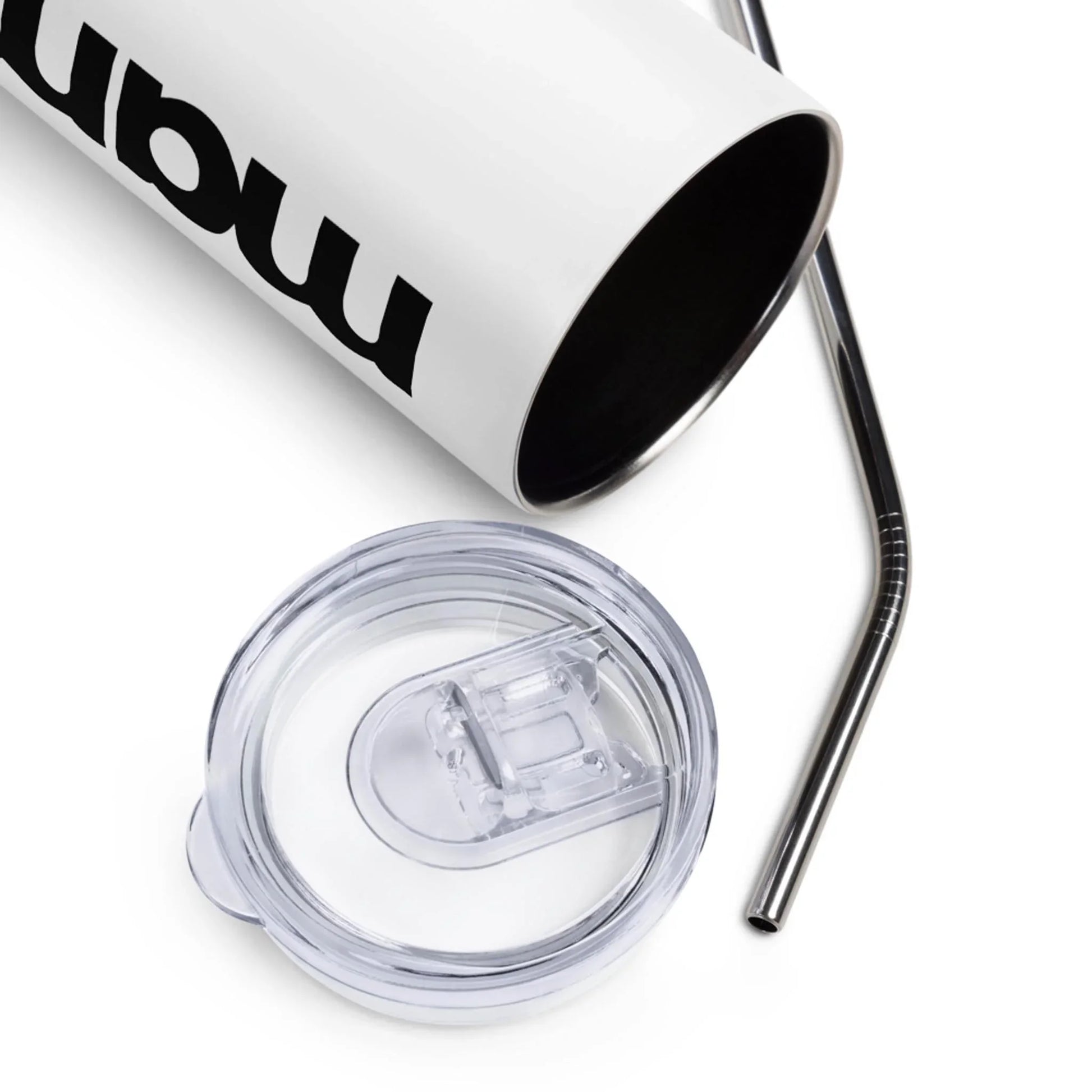 A white Mambí tumbler with bold black text, shown with its clear plastic lid and a metal straw placed beside it on a white surface.