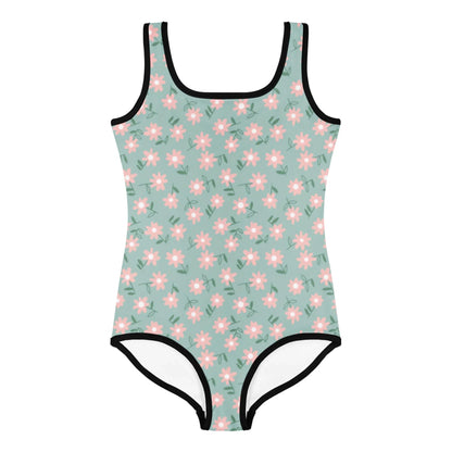 The Sara One-Piece Swimsuit by Printful for toddlers and little kids features vibrant pink and white daisy prints with green leaves on a light green background, black trim, and offers UPF sun protection for safe fun in the sun.
