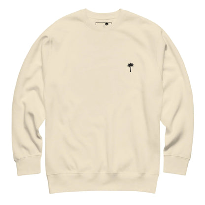 Cream-colored Mambí crewneck sweatshirt with long sleeves and a small black palm tree graphic on the left chest.