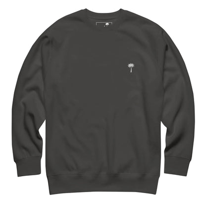 A plain black Mambí crewneck sweatshirt with a small white embroidered palm tree logo on the left chest. The sweatshirt features long sleeves and a relaxed fit.