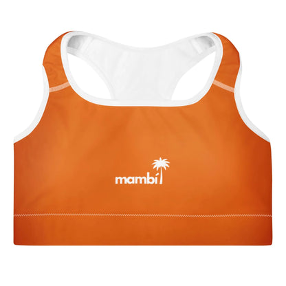 An orange sports bra with white trim and racerback design features the word Mambí and a palm tree logo in white on the front, complemented by a white interior lining.