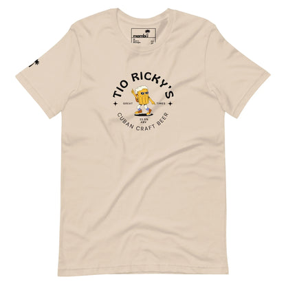 Beige T-shirt with Tio Rickys Cuban Craft Beer and Mambí printed on the front, featuring a cartoon beer mug character with arms raised and wearing sunglasses. Small palm tree graphic on the left sleeve.