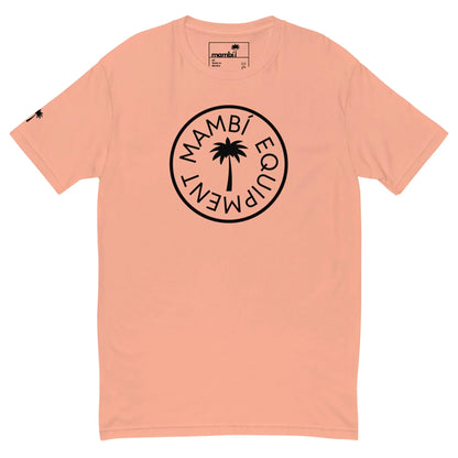 Peach-colored Mambí T-shirt featuring a black circular logo with a palm tree in the center and “MAMBÍ EQUIPMENT” around it; a small black palm tree decorates the left sleeve.