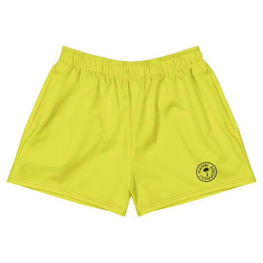 Bright yellow athletic shorts with an elastic waistband and a small circular black Mambí logo on the left leg featuring a star in the center. Shorts are laid flat on a white background.