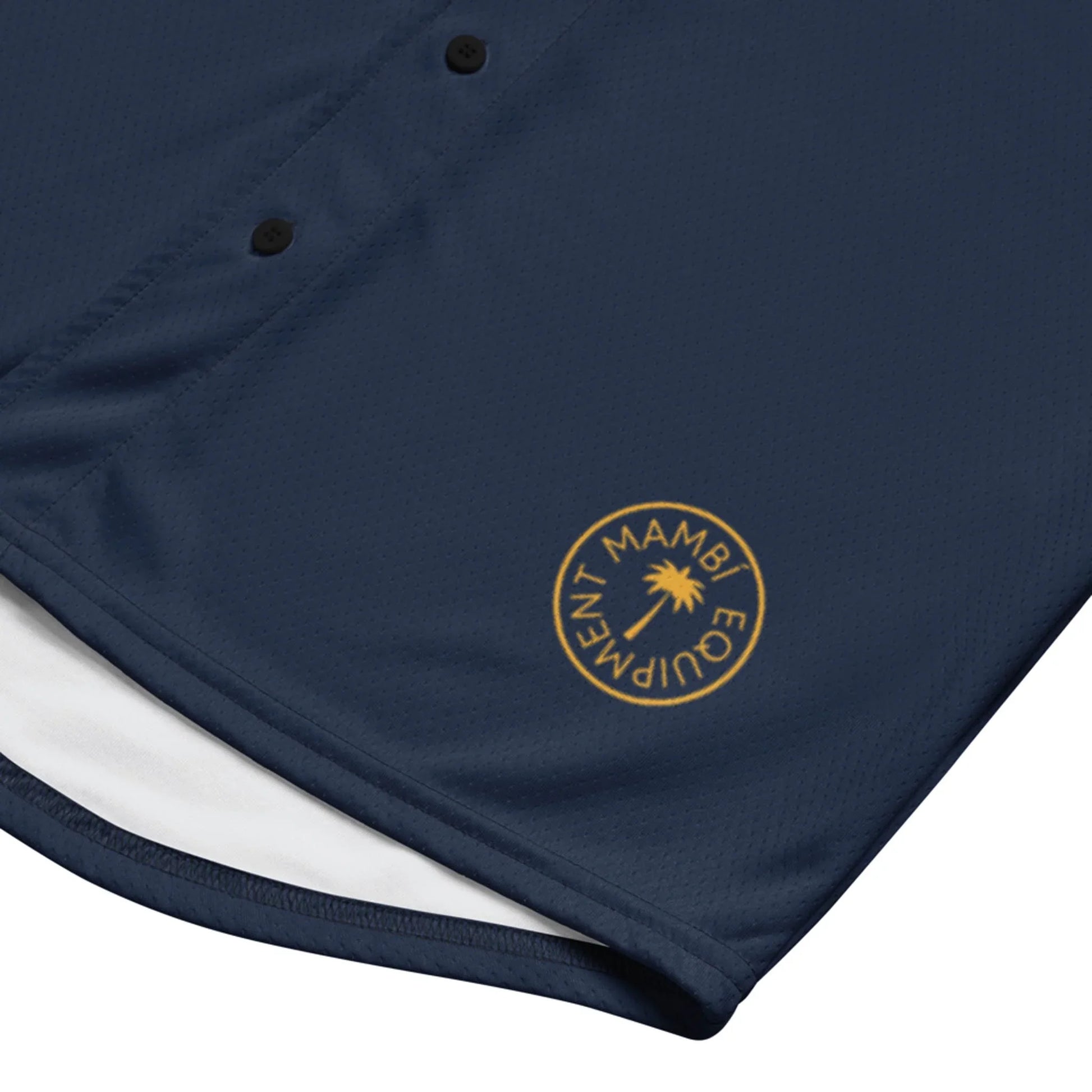 The Zoilo Classic Baseball Jersey by Printful features navy blue fabric, black buttons for a timeless look, and a gold circular MAMBI EQUIPMENT logo near the hem, inspired by vintage baseball jerseys.